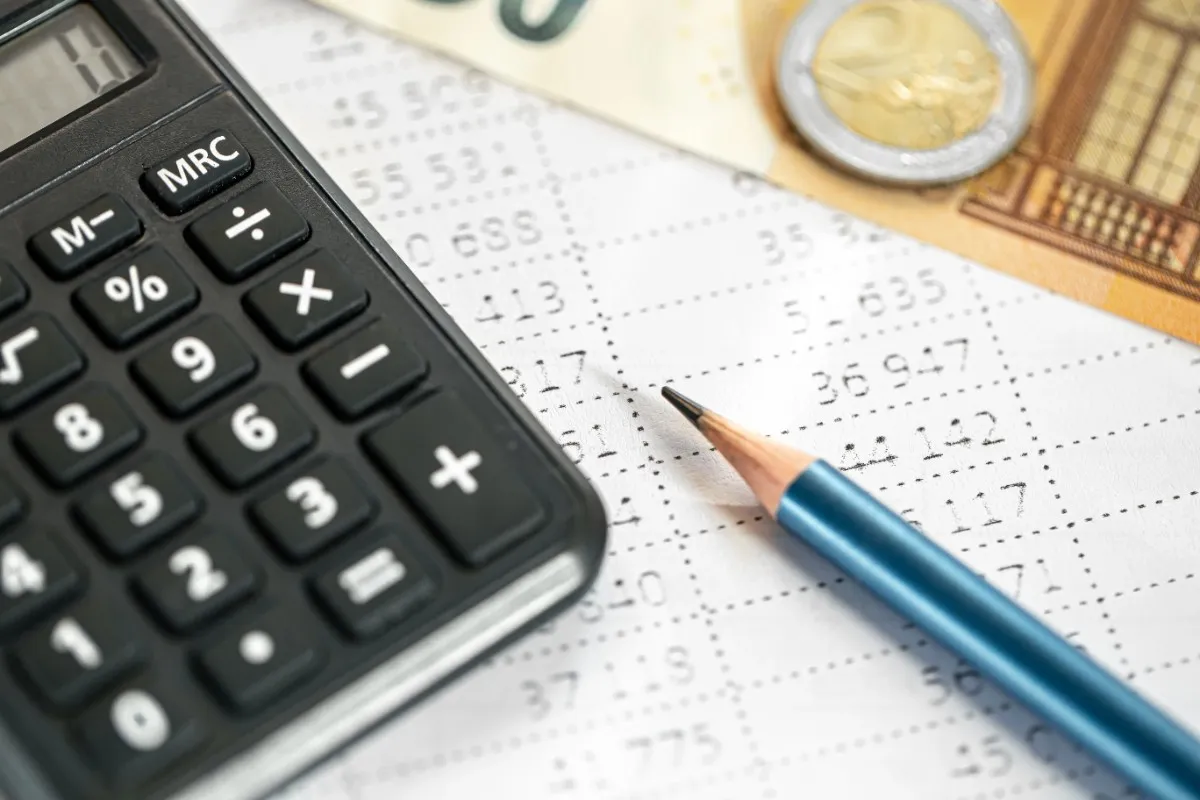Tally Gold Partner Solutions for UAE Businesses showcased through a calculator, financial documents, currency notes, and a pencil, symbolizing accounting, VAT compliance, and business management.